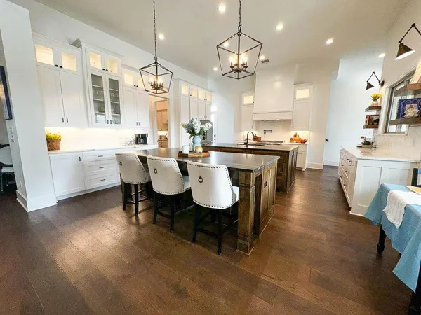 a large kitchen with a table and chairs
