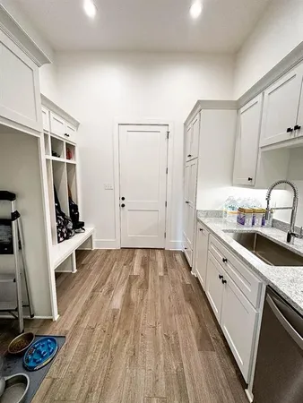 a kitchen with granite countertop a sink stove and refrigerator