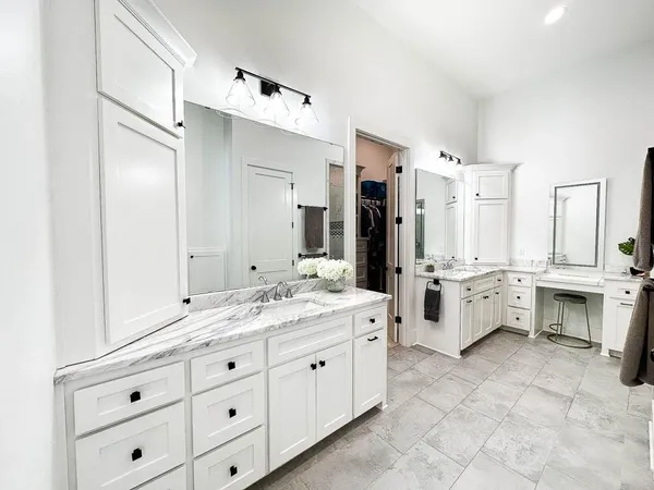 a large white bathroom with double vanity