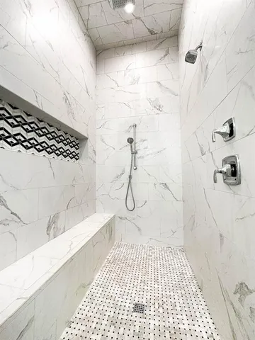 a bathroom with a bathtub and a shower