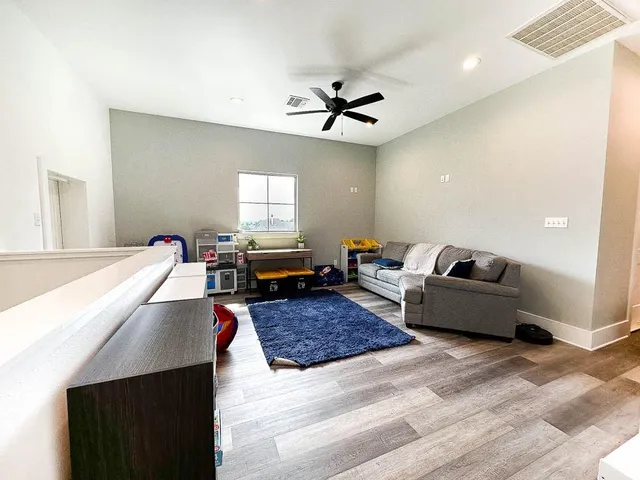 a bathroom with a granite countertop sink mirror and toilet