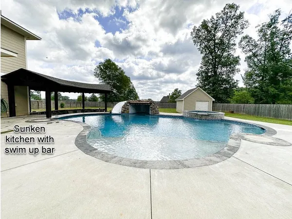 a view of a patio with swimming pool table and chairs