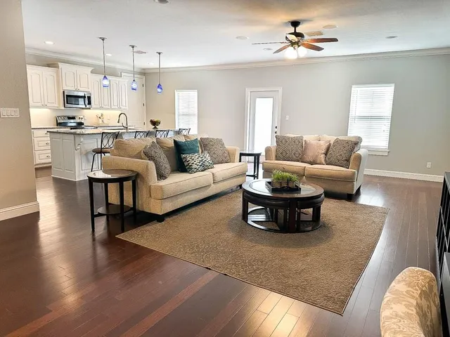 a living room with furniture and kitchen view