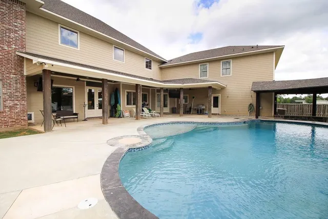 a view of a patio with swimming pool table and chairs