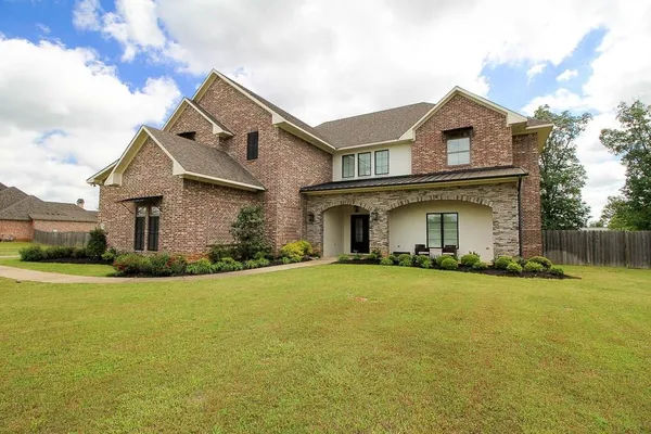 a front view of house with yard and green space