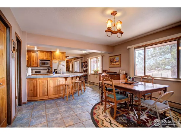 a view of a dining room with furniture and window