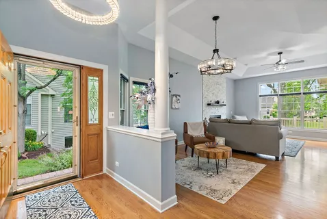 a living room with furniture and a chandelier