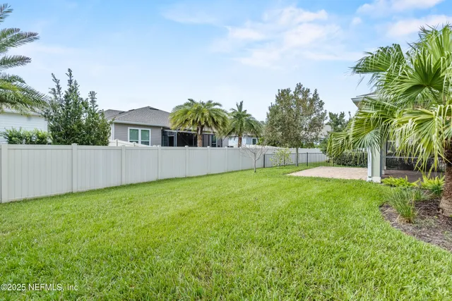 a view of a backyard with a slide and a child swing