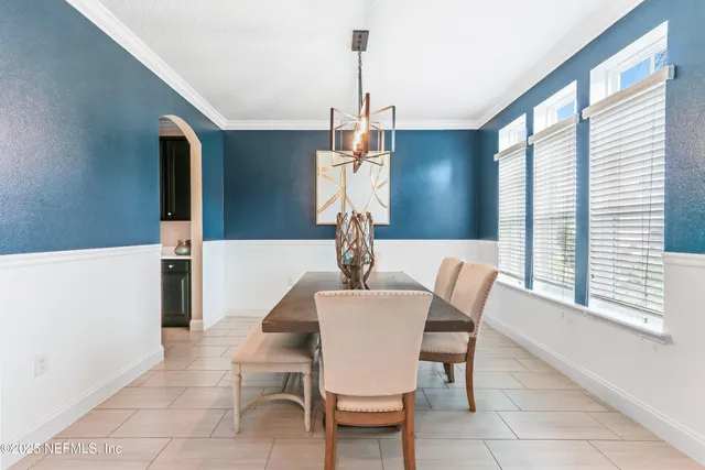 a kitchen with a refrigerator a stove a sink and a window