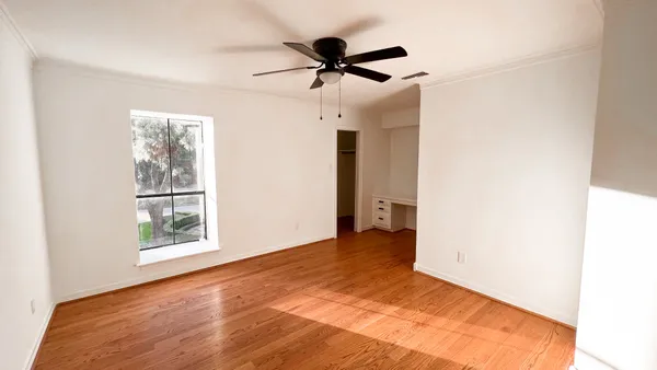 a view of an empty room and a window