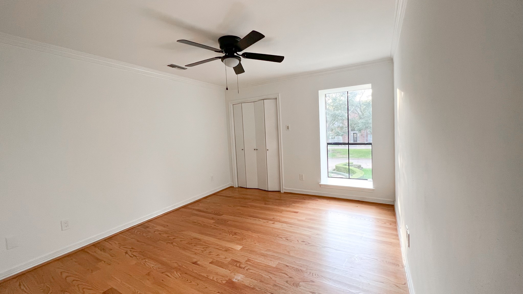 372 Robbins Drive Houston, TX 77024 - Photo 13 of 18 The remaining upstairs secondary bedroom offers a thoughtfully placed window to allow natural light while preserving privacy, and closet space, ensuring both functionality and style.