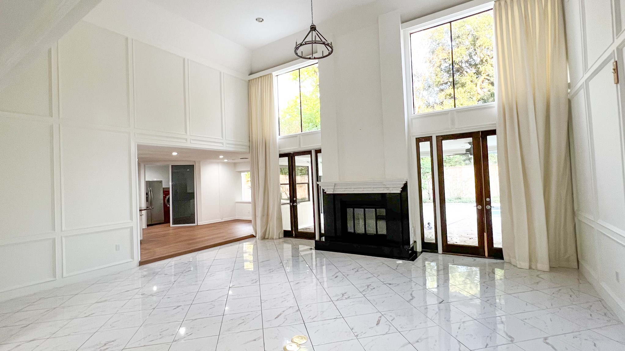 372 Robbins Drive Houston, TX 77024 - Photo 2 of 18 The stunning living room offers soaring ceilings and oversized windows that fill the room with natural light, creating the perfect space for gatherings. A granite fireplace serves as the focal point of the living room.