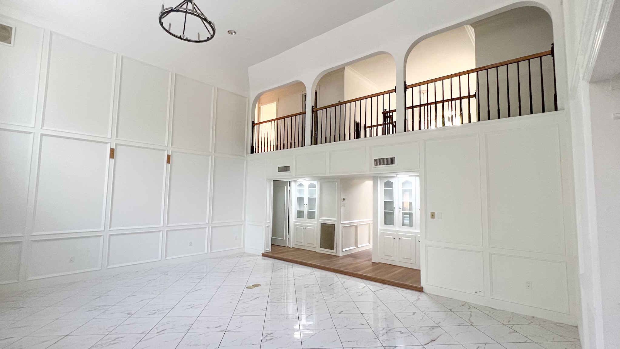 372 Robbins Drive Houston, TX 77024 - Photo 4 of 18 Another view of the living room showcases its high ceilings and wood detailing that makes it a wonderful setting for both lively gatherings and quiet evenings. The central location between the kitchen and living spaces creates an effortless flow for hosting and enjoying time with family.
