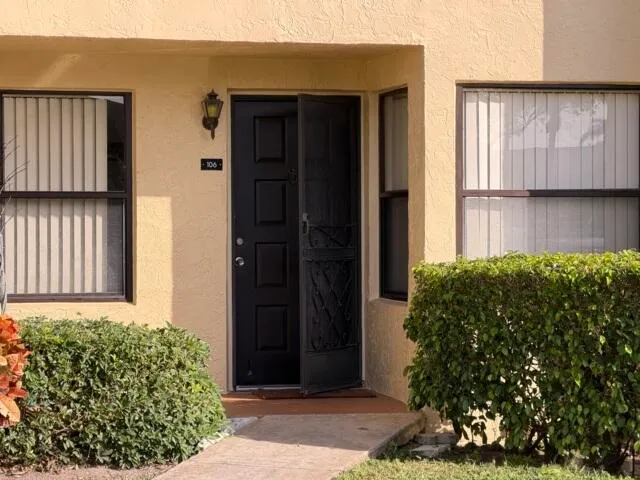 a couple of potted plants in front of door