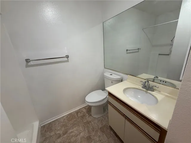 a bathroom with a sink toilet and mirror