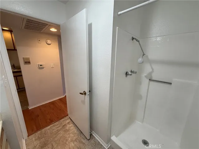 a bathroom with a shower and a sink