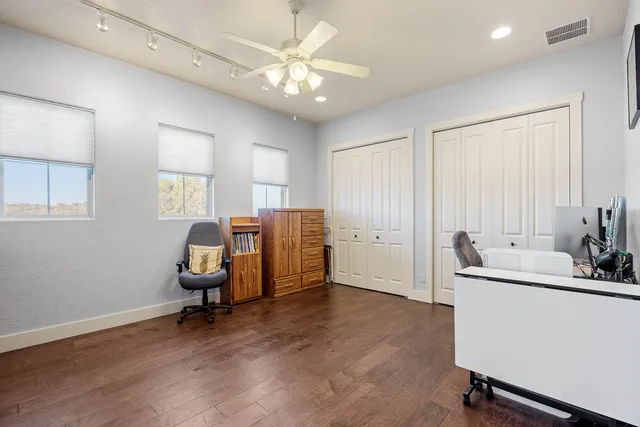 a view of a workspace with furniture and a window
