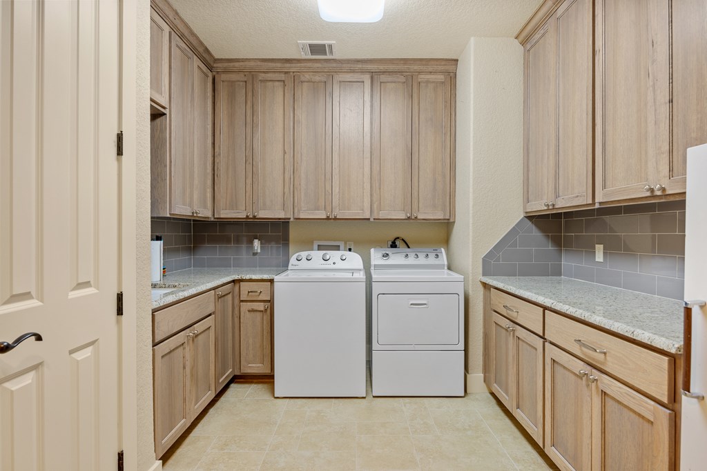 3704 Club View Court Kerrville, TX 78028 - Photo 20 of 25 a utility room with granite countertop cabinets and sink