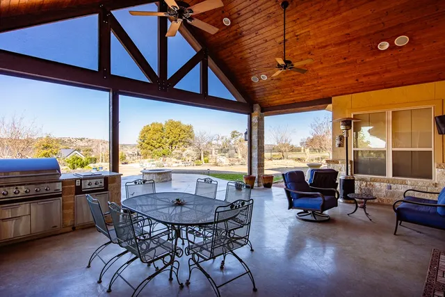a view of a dining room with furniture large windows and wooden floor