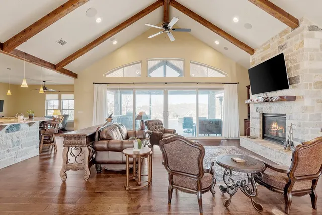 a living room with fireplace furniture and a flat screen tv