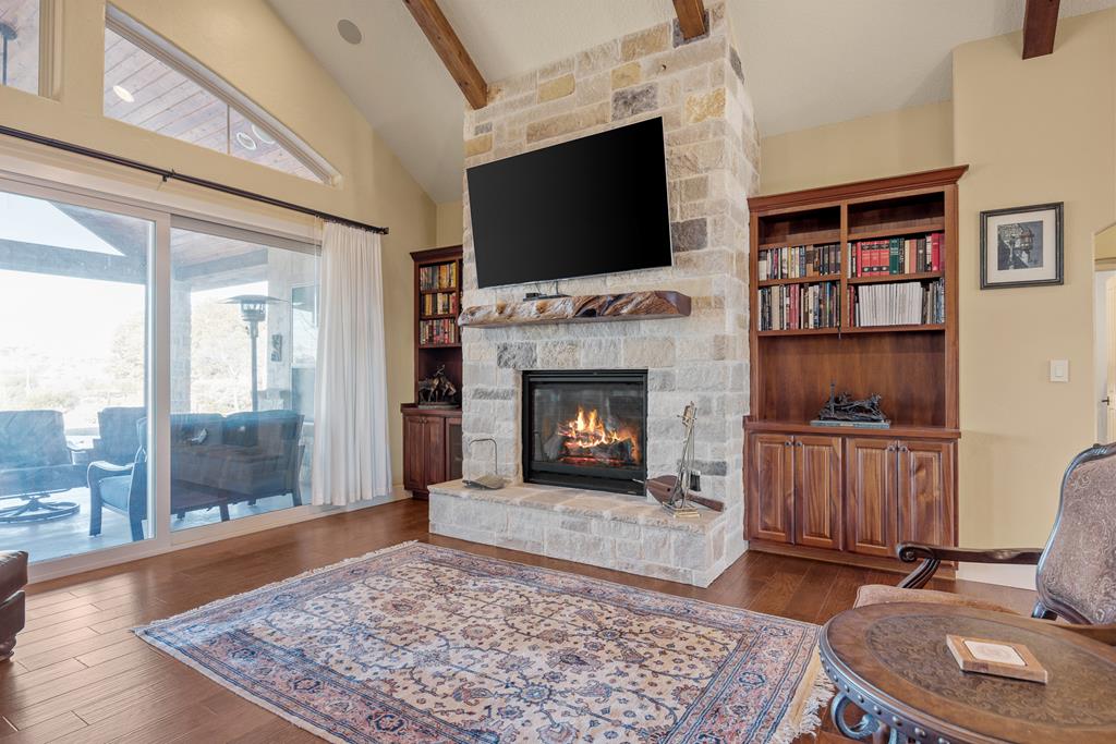 3704 Club View Court Kerrville, TX 78028 - Photo 6 of 25 a living room with a fireplace and a flat screen tv
