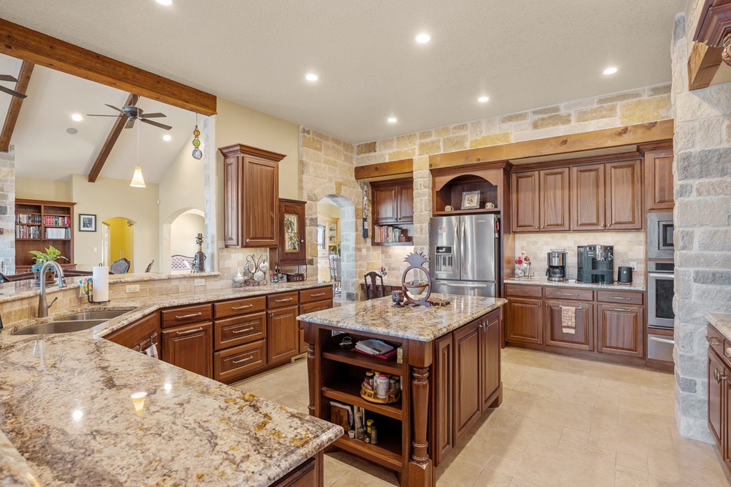 3704 Club View Court Kerrville, TX 78028 - Photo 7 of 25 a large kitchen with kitchen island a sink stove and cabinets