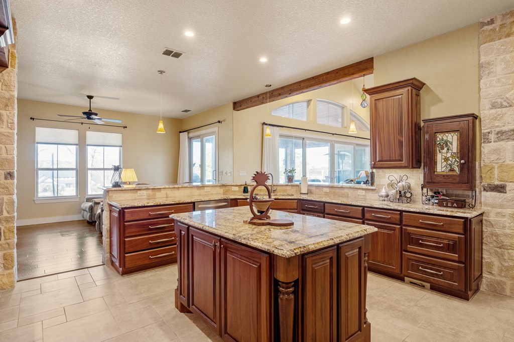 3704 Club View Court Kerrville, TX 78028 - Photo 8 of 25 a kitchen with stainless steel appliances granite countertop a sink and a stove