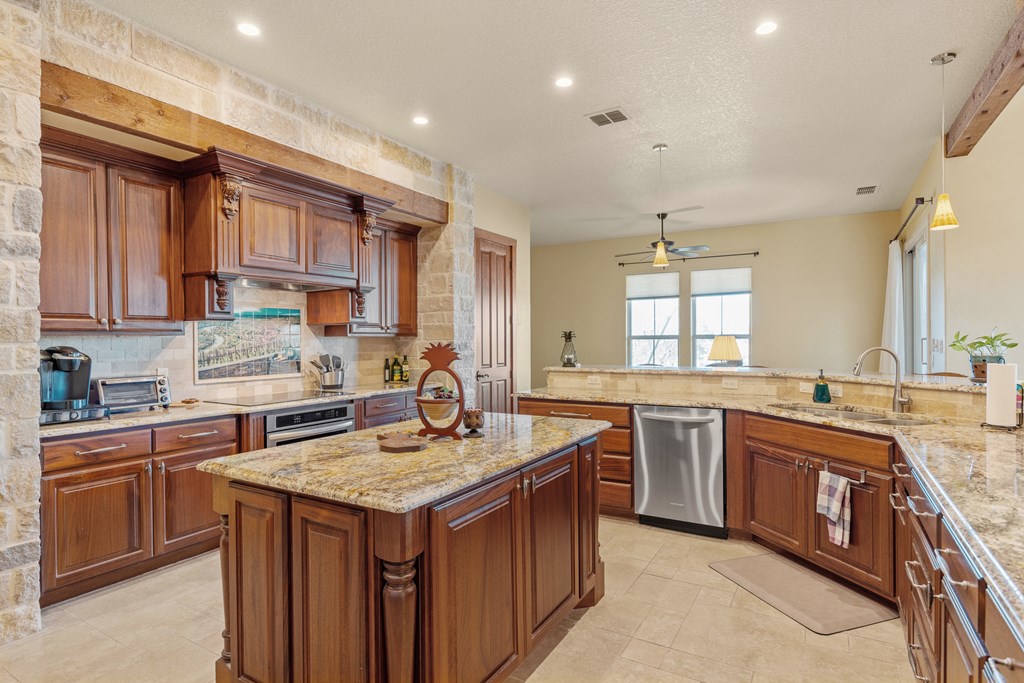 3704 Club View Court Kerrville, TX 78028 - Photo 9 of 25 a kitchen with a sink stove and cabinets