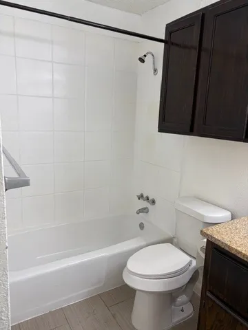 a bathroom with a toilet and a bathtub