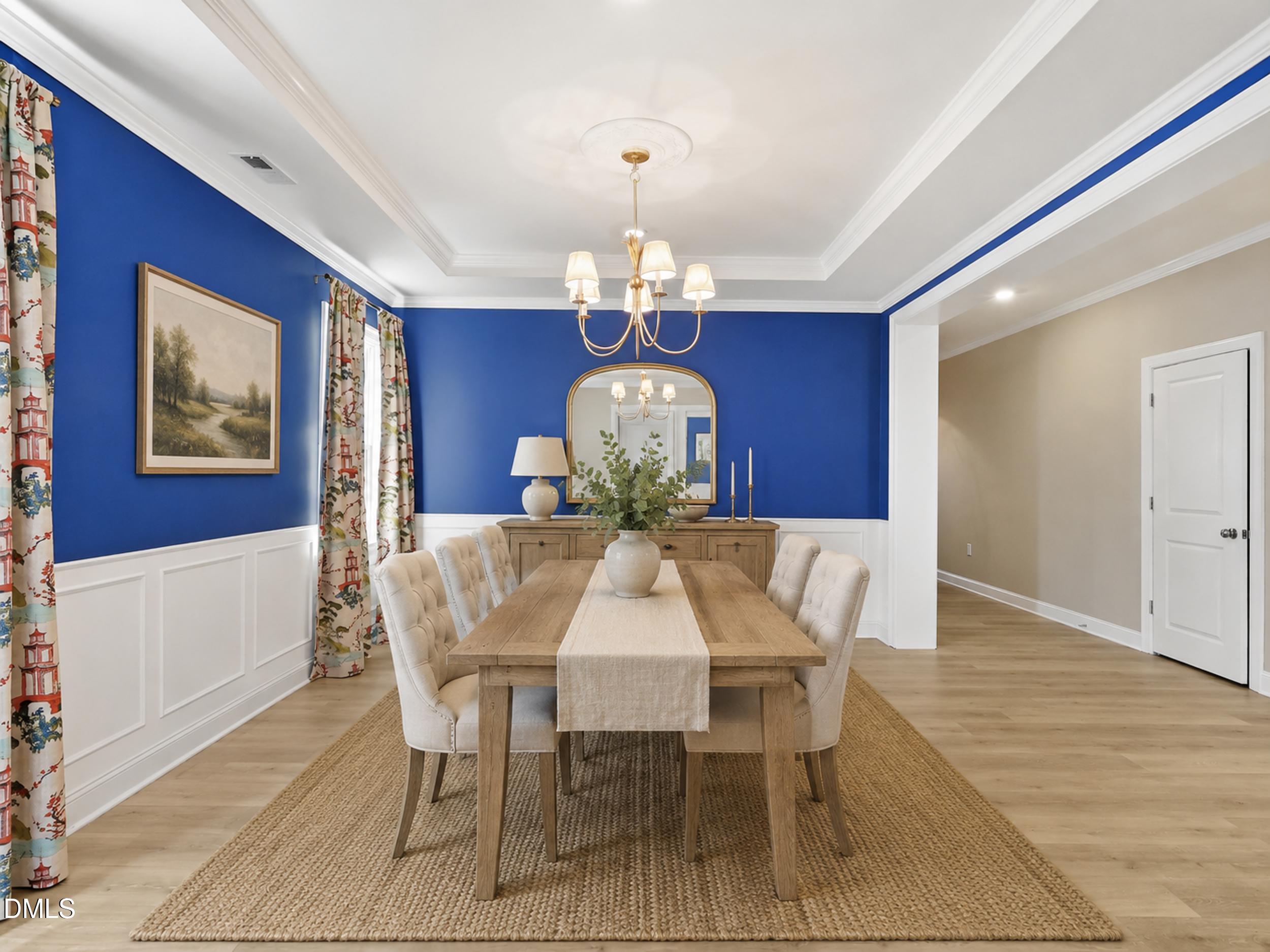 2709 Womble Ridge Drive New Hill, NC 27562 - Photo 10 of 60 a view of a dining room with furniture wooden floor and chandelier