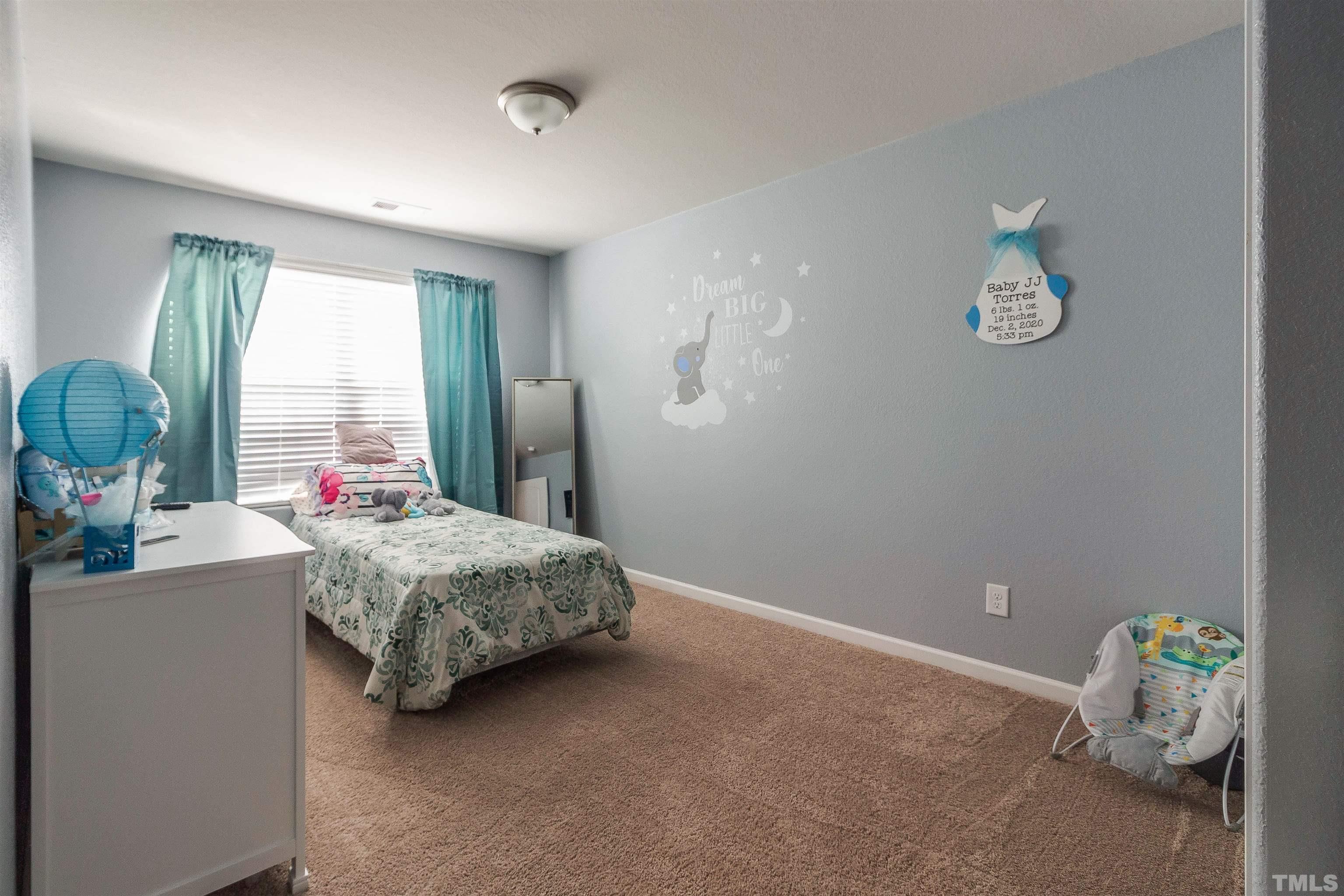 232 Rustling Way Zebulon, NC 27597 - Photo 11 of 14 a bedroom with a bed and a window