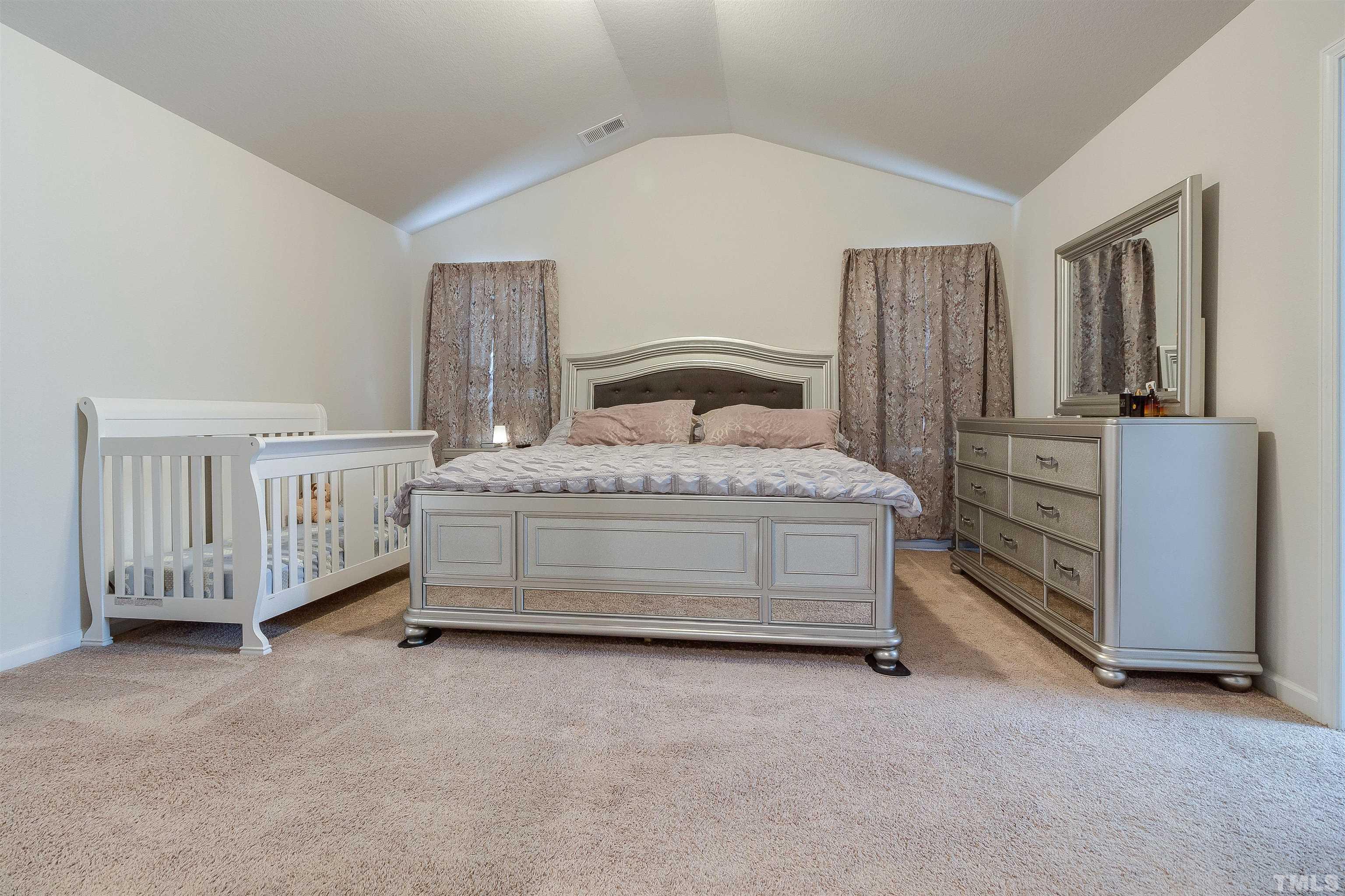 232 Rustling Way Zebulon, NC 27597 - Photo 12 of 14 a bedroom with a bed table and a window
