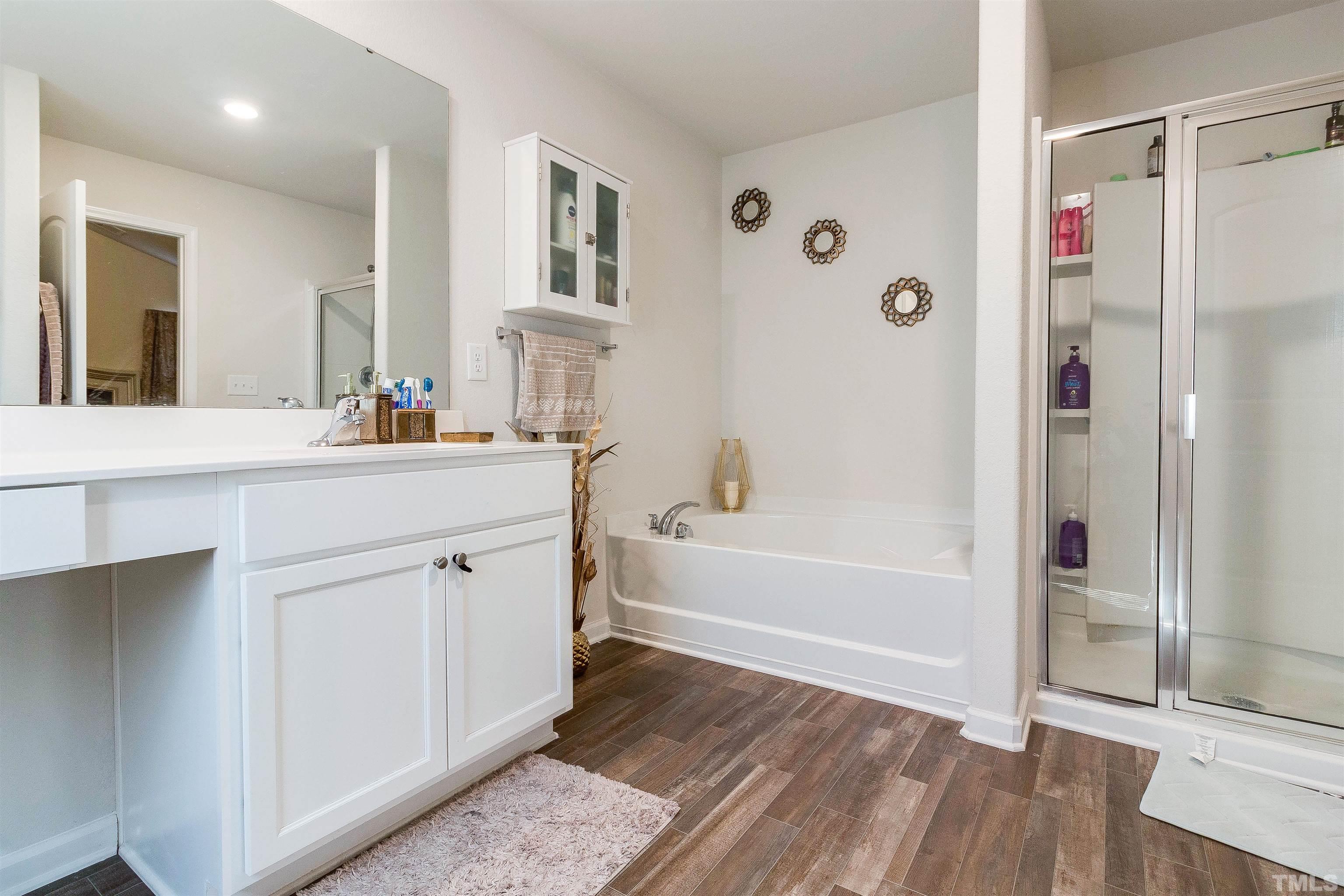 232 Rustling Way Zebulon, NC 27597 - Photo 13 of 14 a bathroom with a tub sink shower and mirror