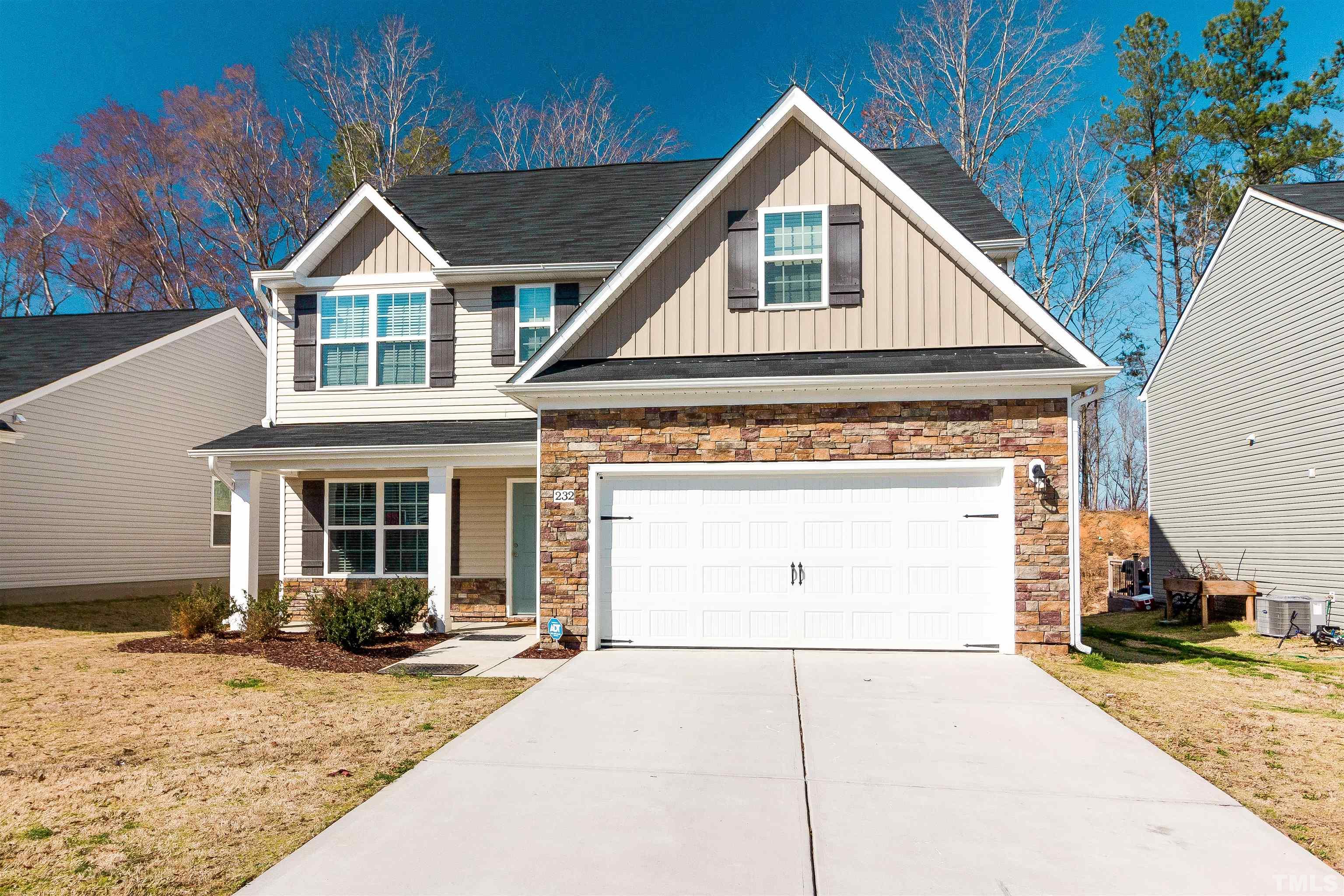232 Rustling Way Zebulon, NC 27597 - Photo 2 of 14 a view of a house with a yard and garage