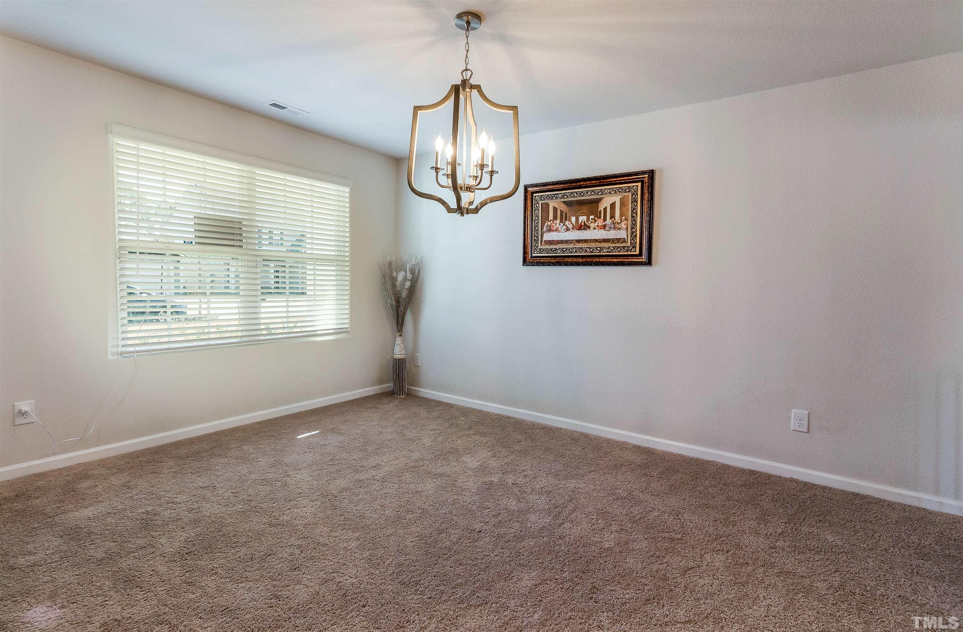 232 Rustling Way Zebulon, NC 27597 - Photo 4 of 14 an empty room with windows and fan