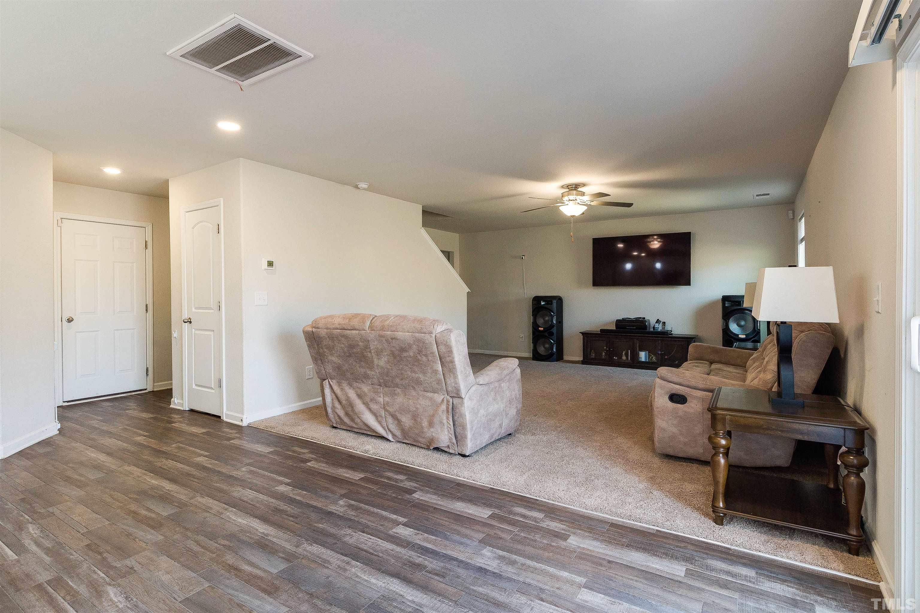 232 Rustling Way Zebulon, NC 27597 - Photo 7 of 14 a living room with furniture and a wooden floor