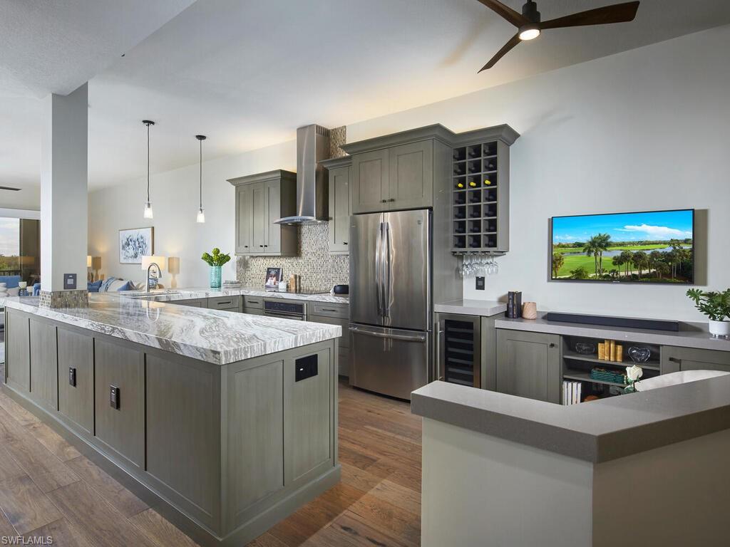 7655 Pebble Creek Circle, Unit 404 Naples, FL 34108 - Photo 1 of 19 a kitchen with stainless steel appliances a sink stove and refrigerator
