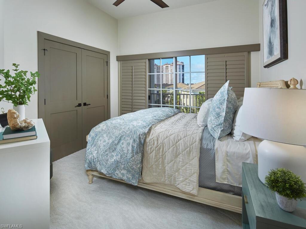 7655 Pebble Creek Circle, Unit 404 Naples, FL 34108 - Photo 12 of 19 a bedroom with a bed and a potted plant