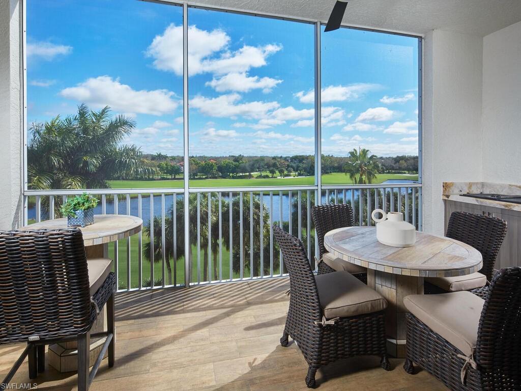 7655 Pebble Creek Circle, Unit 404 Naples, FL 34108 - Photo 15 of 19 a view of a balcony with a table and chairs