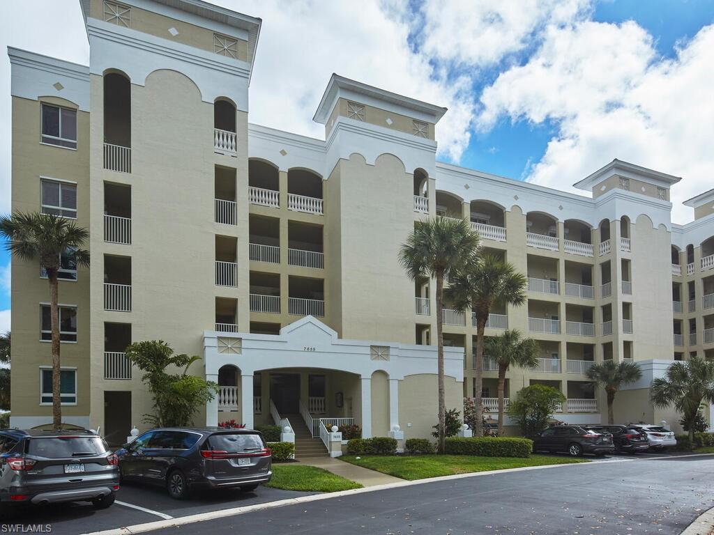 7655 Pebble Creek Circle, Unit 404 Naples, FL 34108 - Photo 16 of 19 a view of building with parking space and parking