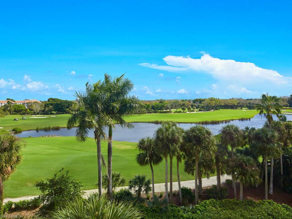 7655 Pebble Creek Circle, Unit 404 Naples, FL 34108 - Photo 2 of 19 a view of a lake with a big yard