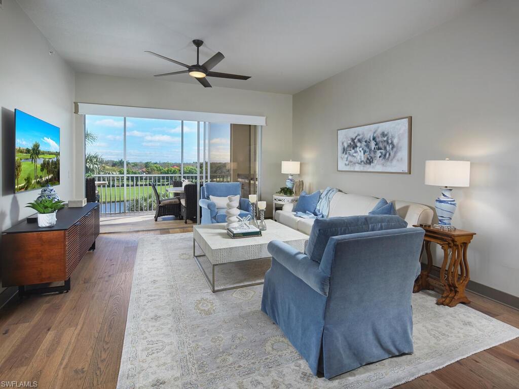7655 Pebble Creek Circle, Unit 404 Naples, FL 34108 - Photo 3 of 19 a living room with furniture and a large window