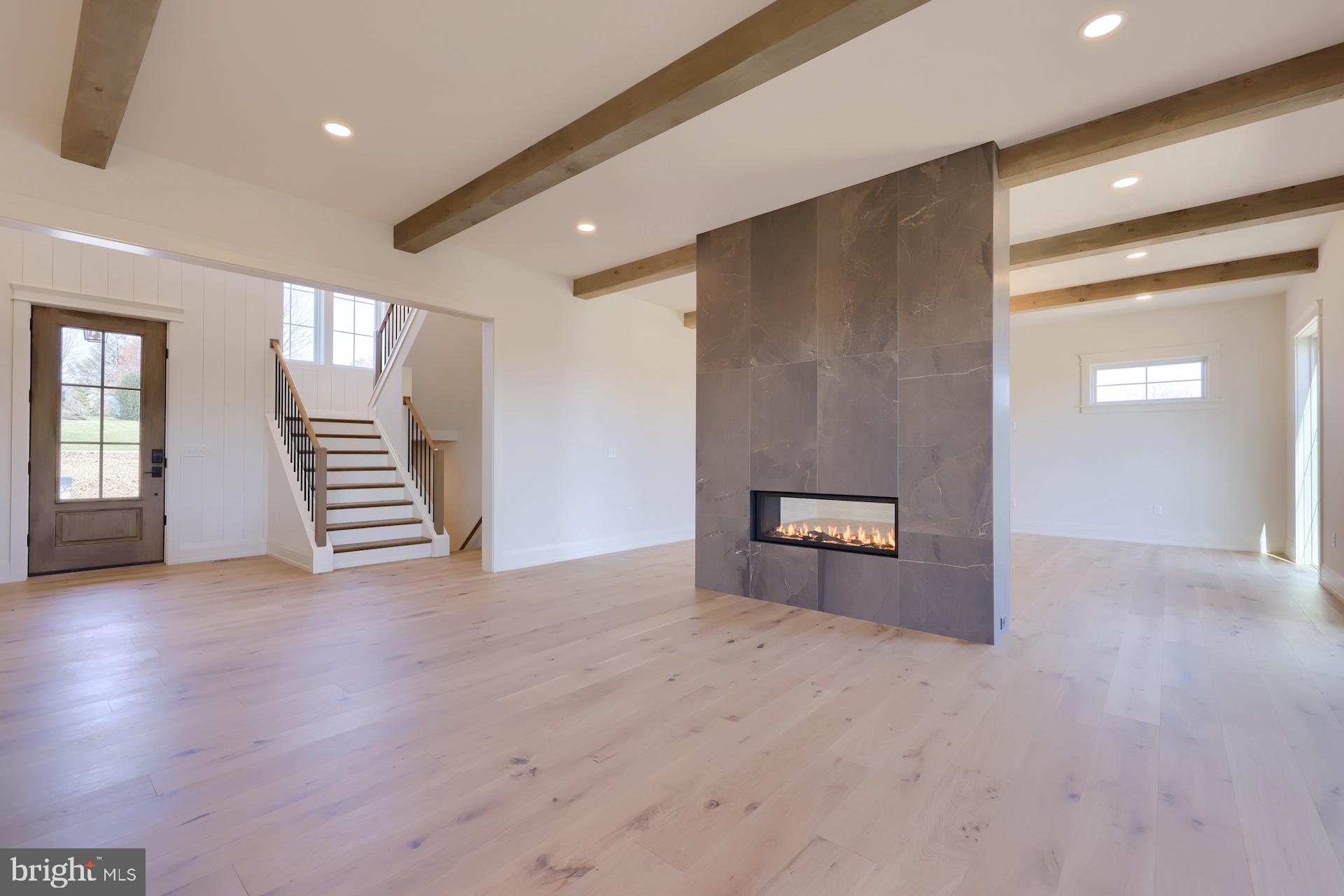 1233 Hunsicker Road Lancaster, PA 17601 - Photo 16 of 23 an empty room with wooden floor and stairs