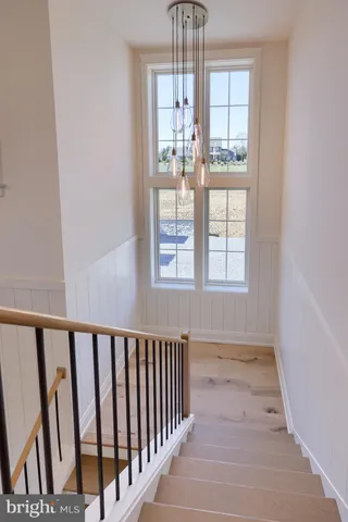 a bathroom with a double vanity sink a toilet a mirror and shower