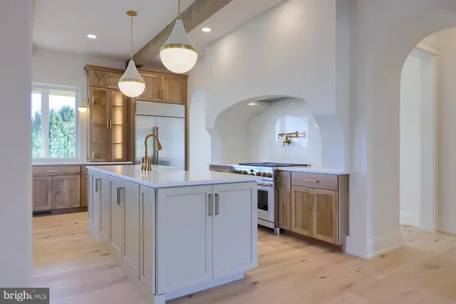 a large kitchen with granite countertop a stove and a sink