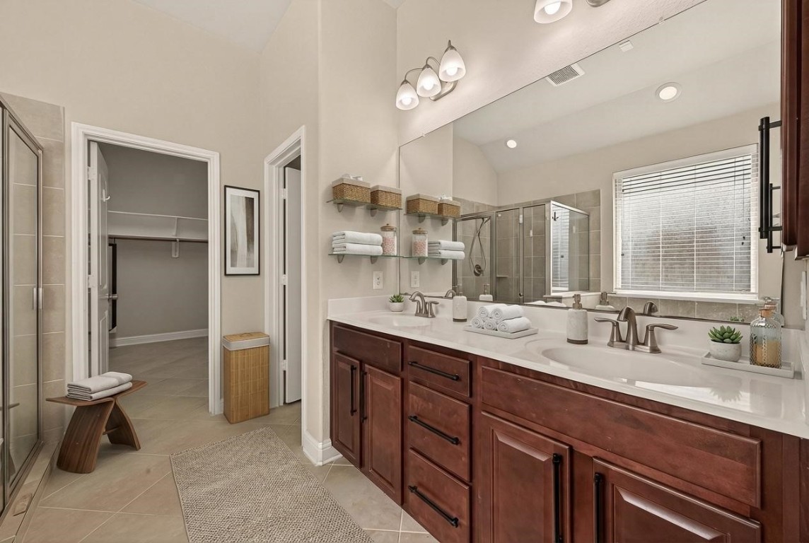 107 Angel Hollow Lane Rosenberg, TX 77469 - Photo 17 of 50 This virtually staged primary bath highlights a massive mirror and dual-sink setup, ensuring your morning routine never feels like a squeeze. (Virtual staging)