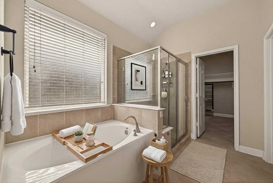 107 Angel Hollow Lane Rosenberg, TX 77469 - Photo 19 of 50 Imagine soaking in that deep tub under a sunlit window, or hopping into the separate glass shower when you’re in a "get-up-and-go" mood. (Virtual staging)