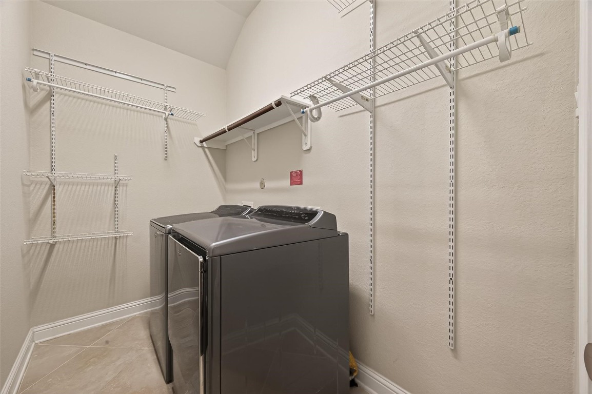 107 Angel Hollow Lane Rosenberg, TX 77469 - Photo 5 of 50 The utility room is a dream of organization with adjustable-height racks that handle everything from heavy coats to delicate linens.