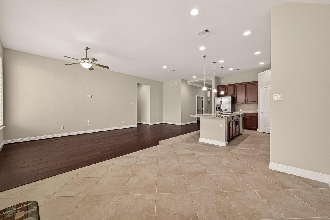 107 Angel Hollow Lane Rosenberg, TX 77469 - Photo 7 of 50 You’ll never miss a beat in this expansive open-concept layout, where the kitchen, lounge, and dining areas merge into one big, social masterpiece.