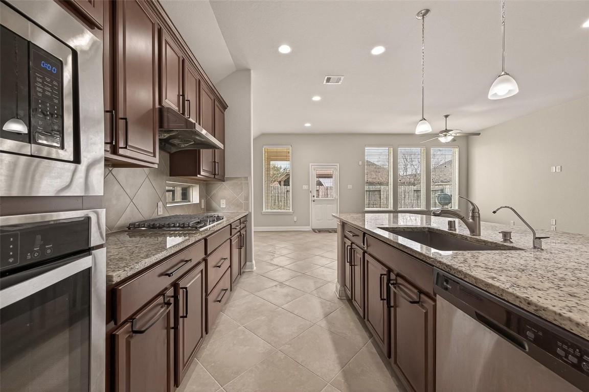 107 Angel Hollow Lane Rosenberg, TX 77469 - Photo 8 of 50 Tucked right between the kitchen and the patio door, the dining area is the perfect place to start your day while watching the sun hit the backyard.